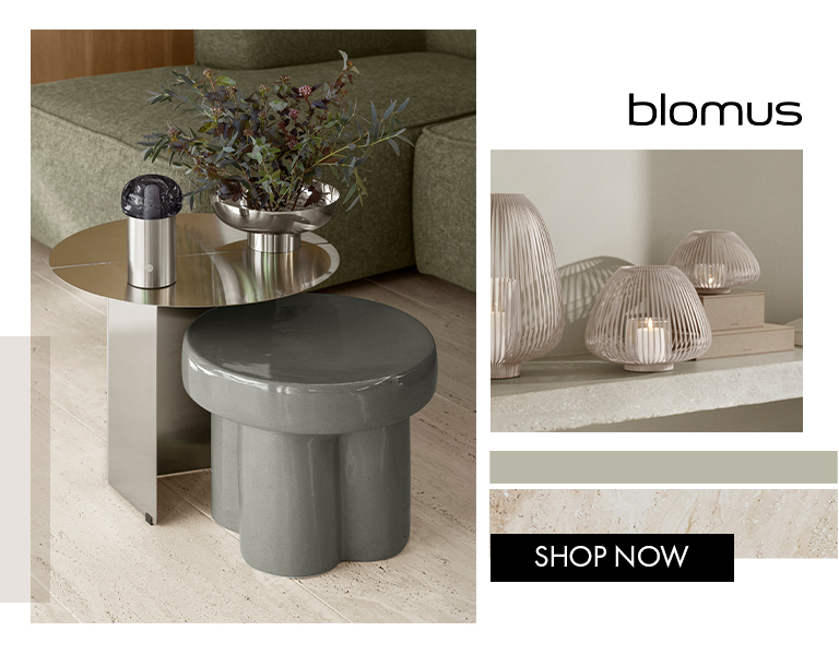 Blomus modern side table with ceramic stool and candle lanterns in a minimalist living room.
