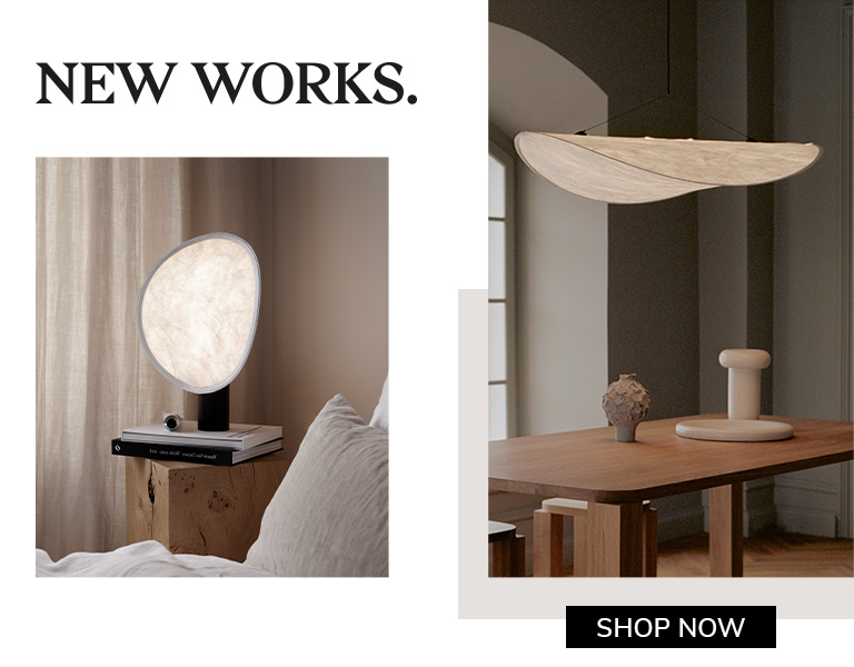 New Works sculptural lighting in soft white tones, featuring a floating pendant lamp and round table lamp in a modern interior.