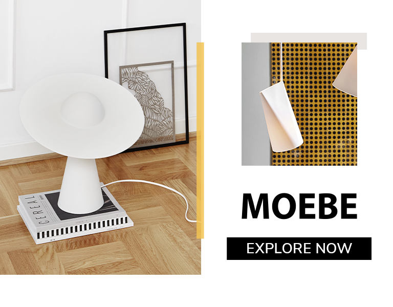 Moebe minimalist white table lamp with sculptural design, styled in a modern interior with wooden flooring and framed artwork